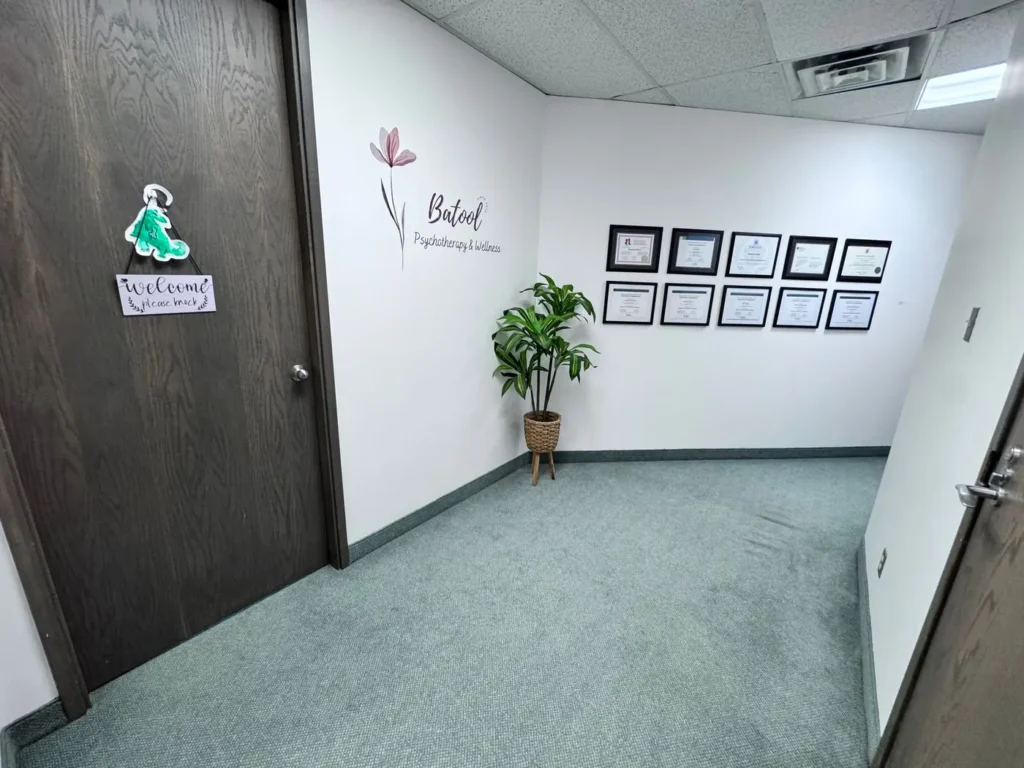 Reception at Batool Psychotherapy & Wellness with framed clinician credentials