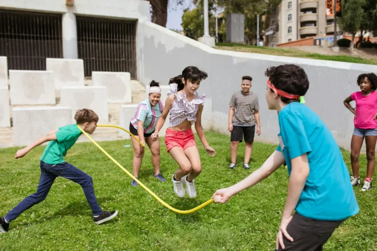 Children playing together outdoors with a skipping rope
