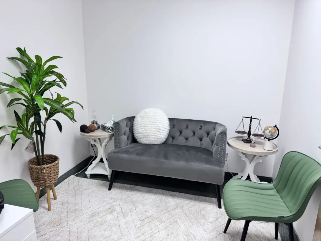 Couples therapy room with a loveseat and armchair at Batool Psychotherapy in Vaughan